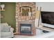 Living room fireplace with brick surround, wooden mantel, and decorative accents at 11072 Quail Ct, Parker, CO 80134