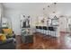 Open-concept living area with modern decor, hardwood floors, and a kitchen with stainless steel appliances at 11072 Quail Ct, Parker, CO 80134