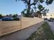 Long newly installed wooden fence enhances privacy and security along the property line and sidewalk at 300 S Lincoln St, Denver, CO 80209