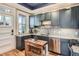 Modern kitchen featuring stylish blue cabinets, granite countertops, and stainless steel appliances at 300 S Lincoln St, Denver, CO 80209