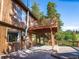 Spacious wooden deck featuring stairs, railings, and views of the surrounding trees and hillside at 10858 Norton Ave, Conifer, CO 80433