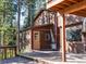Spacious wooden deck with railings and stairs, providing access to the home's side entrance at 10858 Norton Ave, Conifer, CO 80433