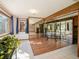 Spacious basement featuring tile floors, wooden beam, mirrored walls, and access to outdoors at 10858 Norton Ave, Conifer, CO 80433