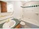 A full bathroom featuring tiled shower-over-tub and green accent tile at 10858 Norton Ave, Conifer, CO 80433