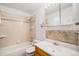 Cozy bathroom featuring a tub-shower combo, vanity with sink, and a decorative tile backsplash at 10858 Norton Ave, Conifer, CO 80433