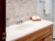 Close up of bathroom sink with mosaic tile wall and towels at 10858 Norton Ave, Conifer, CO 80433