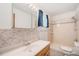 Bathroom featuring a tub-shower combo and vanity with tile backsplash at 10858 Norton Ave, Conifer, CO 80433