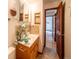 Cozy bathroom featuring a wooden vanity with stylish accents and easy access to adjacent rooms at 10858 Norton Ave, Conifer, CO 80433