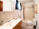 Bathroom featuring walk-in shower with tan tile and decorative accent wall at 10858 Norton Ave, Conifer, CO 80433