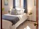 Comfortable bedroom offering a sun-filled atmosphere, a metal bed frame, and a lovely window view at 10858 Norton Ave, Conifer, CO 80433