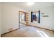 Bright and airy bedroom with mirrored closet doors, and a window with blue curtains at 10858 Norton Ave, Conifer, CO 80433