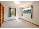 Sunlit bedroom with two windows, carpet flooring, and built in shelving and closet at 10858 Norton Ave, Conifer, CO 80433