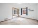 Bright bedroom with neutral carpet, mirrored closet doors, and a window for natural light at 10858 Norton Ave, Conifer, CO 80433