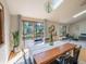Sun-filled dining room featuring a skylight and a sliding door that leads to a deck with lovely views at 10858 Norton Ave, Conifer, CO 80433