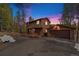 Inviting two-story home with a charming front porch and a detached garage in a wooded setting at 10858 Norton Ave, Conifer, CO 80433