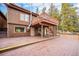 Two-story wood home with a large wraparound deck and second story balcony offering outdoor living at 10858 Norton Ave, Conifer, CO 80433