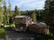 Charming exterior view of a two-story home with a deck and a detached garage at 10858 Norton Ave, Conifer, CO 80433