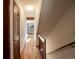 Bright hallway with hardwood floors leading to staircase and living areas at 10858 Norton Ave, Conifer, CO 80433