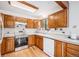 Functional kitchen featuring wooden cabinets, a stainless steel oven, and modern appliances for convenient meal preparation at 10858 Norton Ave, Conifer, CO 80433