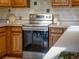 Stainless steel range/oven and wood cabinets, perfect for culinary enthusiasts at 10858 Norton Ave, Conifer, CO 80433