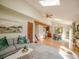 Open-concept living area featuring skylights and beautiful hardwood floors at 10858 Norton Ave, Conifer, CO 80433