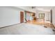 Spacious living room featuring hardwood floors, a beam, a ceiling fan, and an open layout connecting the kitchen at 10858 Norton Ave, Conifer, CO 80433