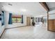 Bright living room with tile flooring, wood beam ceiling, a wood burning stove and large windows at 10858 Norton Ave, Conifer, CO 80433