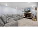 Cozy finished basement with a brick fireplace, TV, and comfortable sectional sofa at 11328 W 27Th Ave, Lakewood, CO 80215