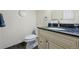 Clean, compact bathroom featuring a vanity with granite countertop, and a modern toilet at 11328 W 27Th Ave, Lakewood, CO 80215