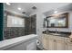 Modern bathroom features a sleek shower and vanity with contemporary fixtures at 11328 W 27Th Ave, Lakewood, CO 80215