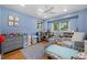 Spacious bedroom with ample natural light and a cozy sitting area near the window at 11328 W 27Th Ave, Lakewood, CO 80215