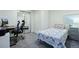 Bright bedroom featuring a sliding closet, neutral carpeting, and space for a home office at 11328 W 27Th Ave, Lakewood, CO 80215