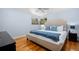 Bright bedroom with hardwood floors, light blue walls, and a comfortable queen-size bed at 11328 W 27Th Ave, Lakewood, CO 80215