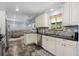 Bright kitchen featuring granite countertops, white cabinetry, stainless steel appliances, and stylish tile backsplash at 11328 W 27Th Ave, Lakewood, CO 80215