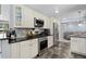 Well-appointed kitchen features stainless steel appliances, granite countertops, subway tile backsplash, and custom cabinetry at 11328 W 27Th Ave, Lakewood, CO 80215
