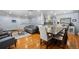 Open-concept living and dining area with hardwood flooring, neutral paint, comfortable furnishings, and ample natural light at 11328 W 27Th Ave, Lakewood, CO 80215