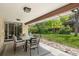 Covered patio featuring an outdoor dining set and easy access to the expansive backyard at 11328 W 27Th Ave, Lakewood, CO 80215