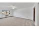 Bright and spacious bedroom featuring neutral carpet, a ceiling fan, and a view out the window at 3022 S Wheeling Way # 205, Aurora, CO 80014