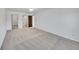 Spacious bedroom with neutral carpeting, white walls, and multiple doorways for easy access to other rooms at 3022 S Wheeling Way # 205, Aurora, CO 80014