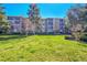 Well-maintained condo building with mature trees, green grass, and manicured landscaping at 3022 S Wheeling Way # 205, Aurora, CO 80014