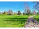 Expansive green lawn with mature trees and walkways; a peaceful and serene landscape at 3022 S Wheeling Way # 205, Aurora, CO 80014