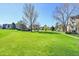Expansive green lawn with mature trees and walkways; a peaceful and serene landscape at 3022 S Wheeling Way # 205, Aurora, CO 80014