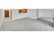 Expansive living area with neutral carpet that transitions seamlessly to a pass-through kitchen at 3022 S Wheeling Way # 205, Aurora, CO 80014