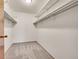 Walk-in closet featuring neutral carpet and several levels of shelving for optimal storage and organization at 3022 S Wheeling Way # 205, Aurora, CO 80014