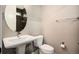 Bathroom with a vintage sink, toilet and a dark brown tiled shower with shower curtain at 2695 W Grand Ave, Littleton, CO 80123