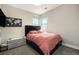 This bedroom features a dark wood frame bed, a white storage unit, and a world map decoration at 2695 W Grand Ave, Littleton, CO 80123
