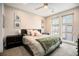 Bright bedroom with a ceiling fan, neutral colors, and a large window at 2695 W Grand Ave, Littleton, CO 80123