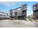 Contemporary townhouse with sleek lines, private balconies, and attached garage in a modern urban community at 2695 W Grand Ave, Littleton, CO 80123