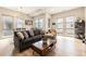 Bright living room features a large sofa, wood floors, and plenty of natural light from large windows at 2695 W Grand Ave, Littleton, CO 80123
