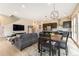 Open-concept living space with modern kitchen, dining area, comfortable seating, and sleek hardwood floors at 2695 W Grand Ave, Littleton, CO 80123